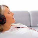 Relaxed-woman-listening-with earbuds